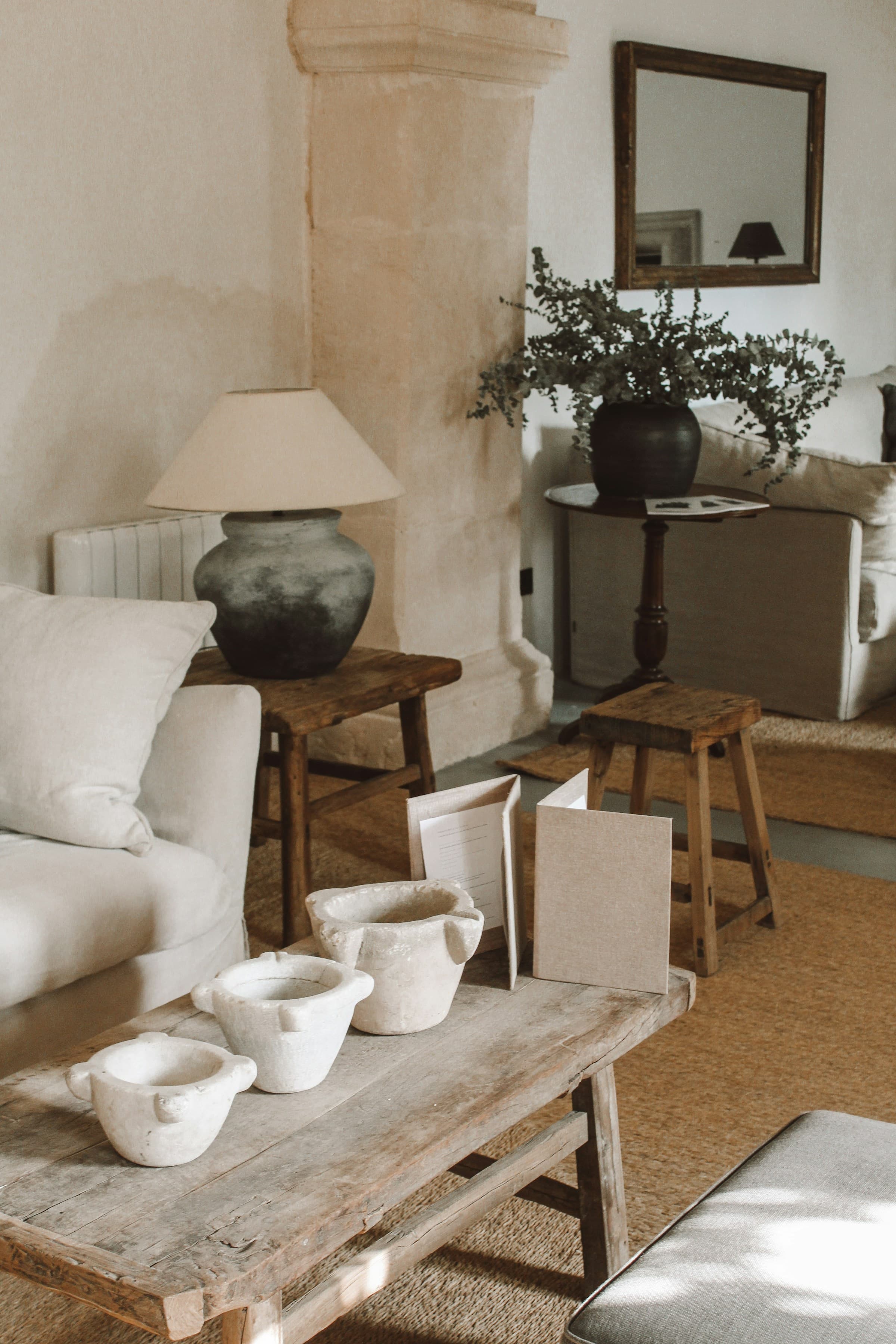 Country-style interior with a wooden coffee table and linen sofa