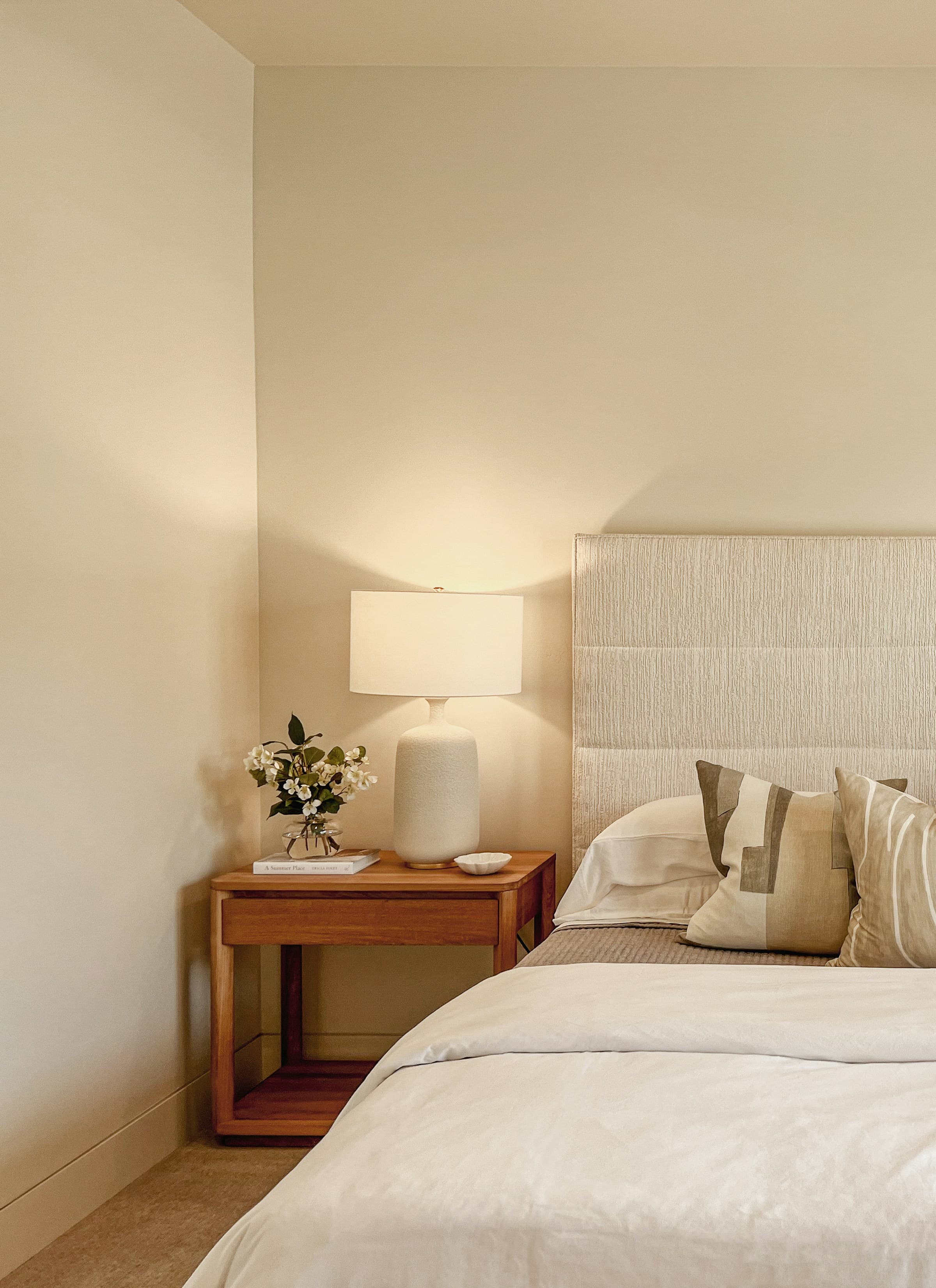 Warm bedroom with a bedside table and lamp