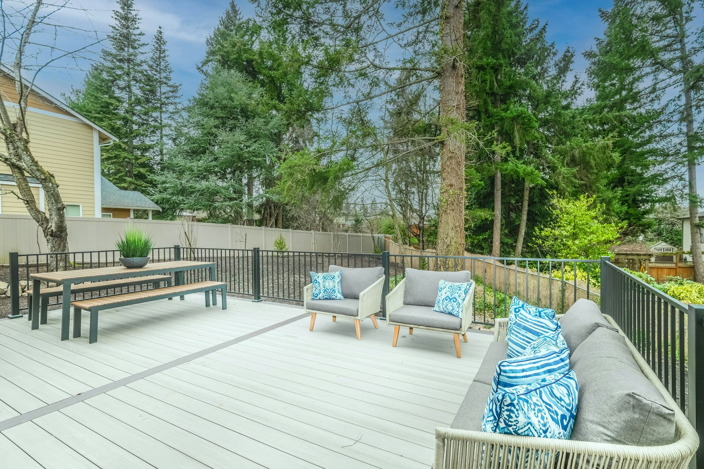 Wooden terrace with a bench and garden furniture